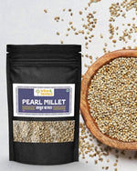 Black pouch pack of unpolished Pearl Millet Bajra Grain next to wooden bowl filled with Bajra seeds on light background