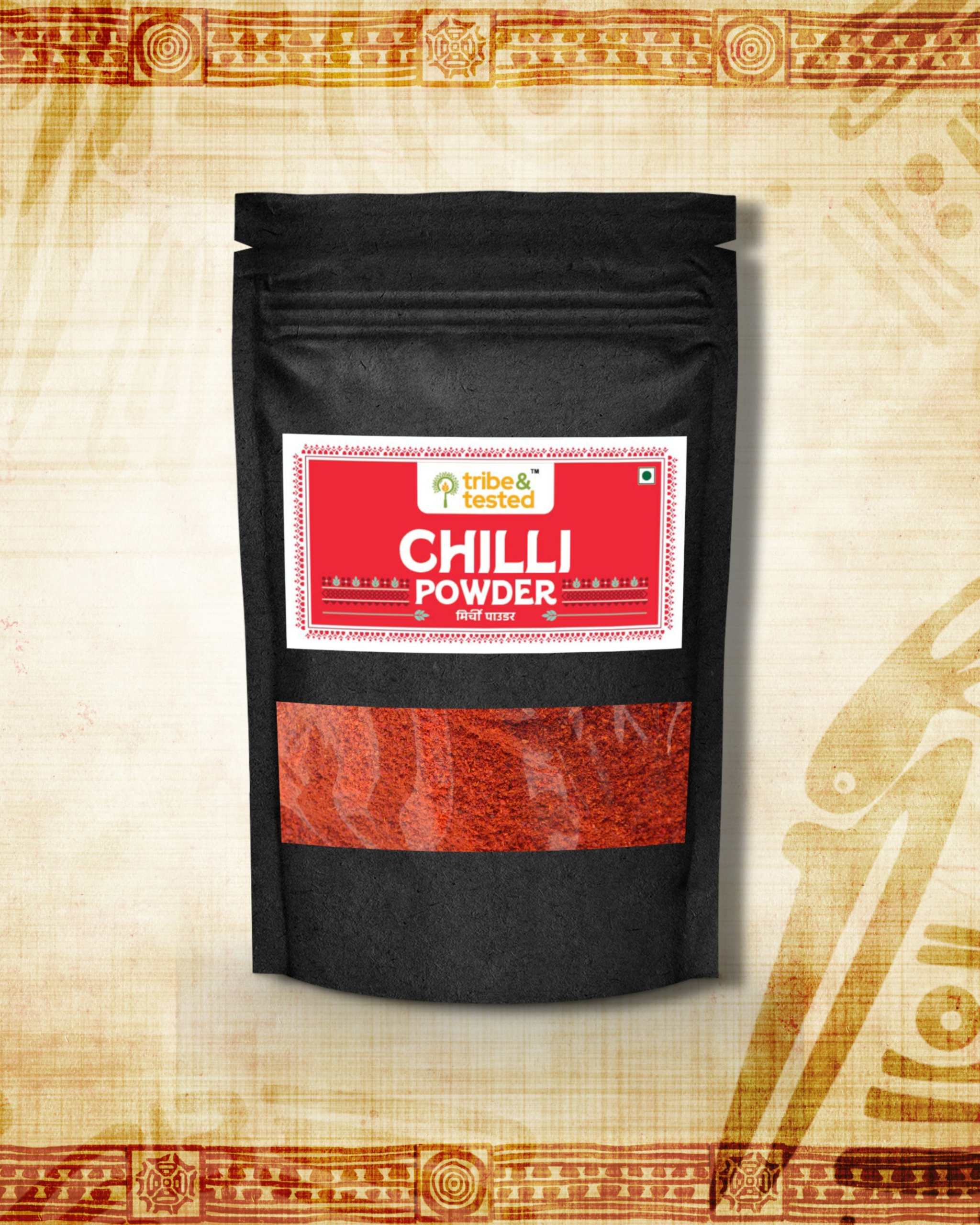 Stone-ground red chilli powder in black resealable pouch with traditional Indian design background