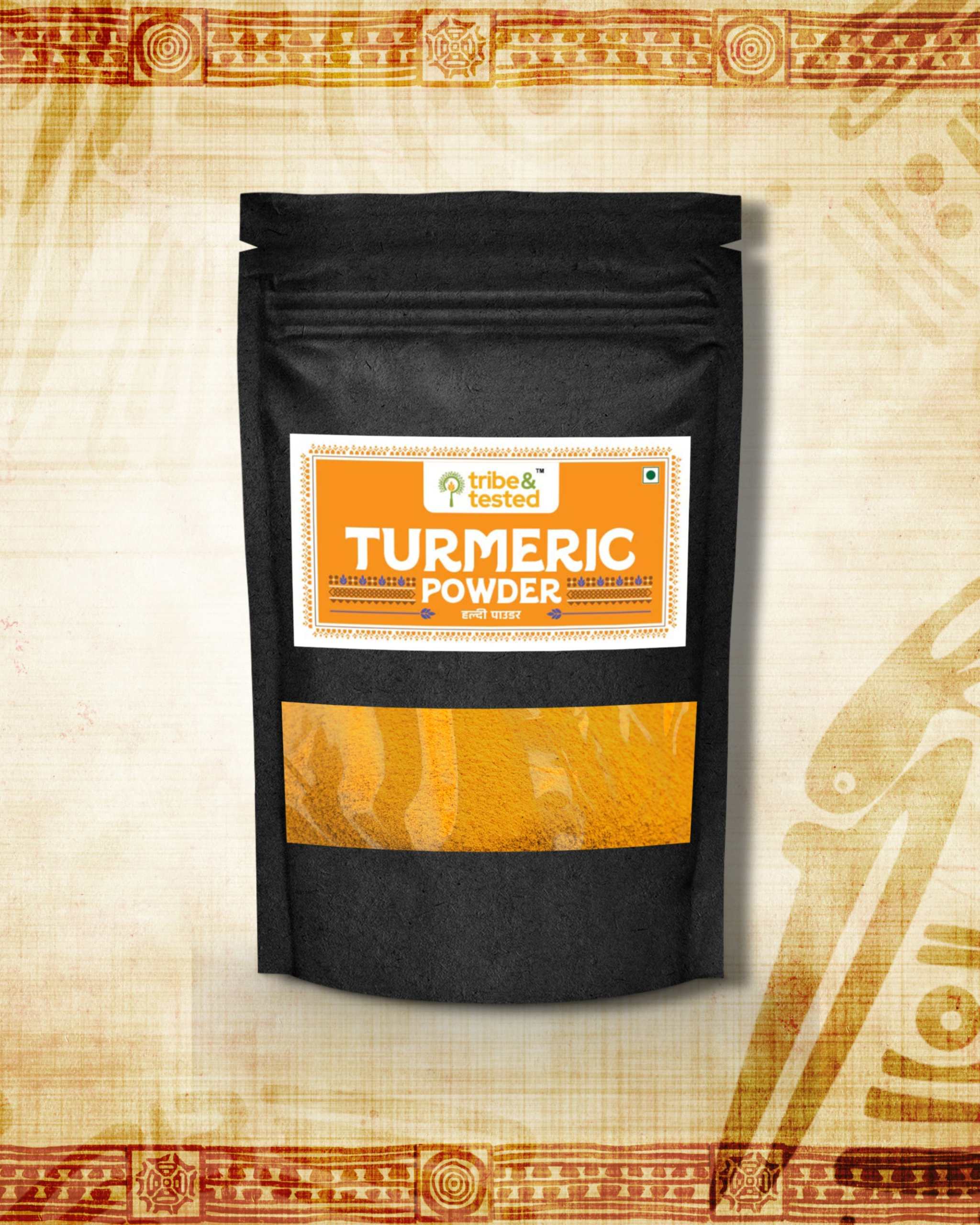 Black pouch packaging of stone-ground turmeric powder with an orange and white label showing "Turmeric Powder" text
