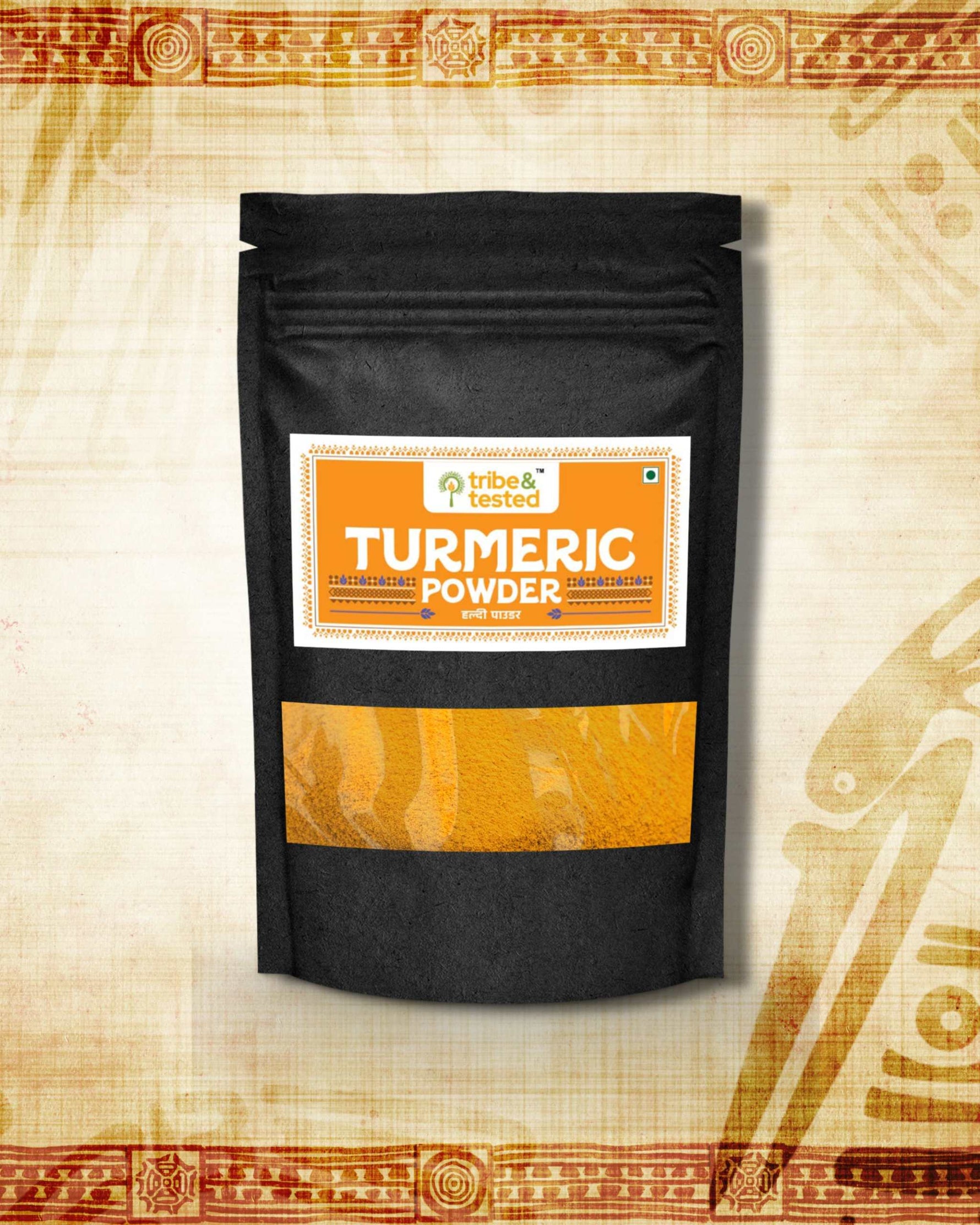 Black pouch packaging of stone-ground turmeric powder with an orange and white label showing "Turmeric Powder" text